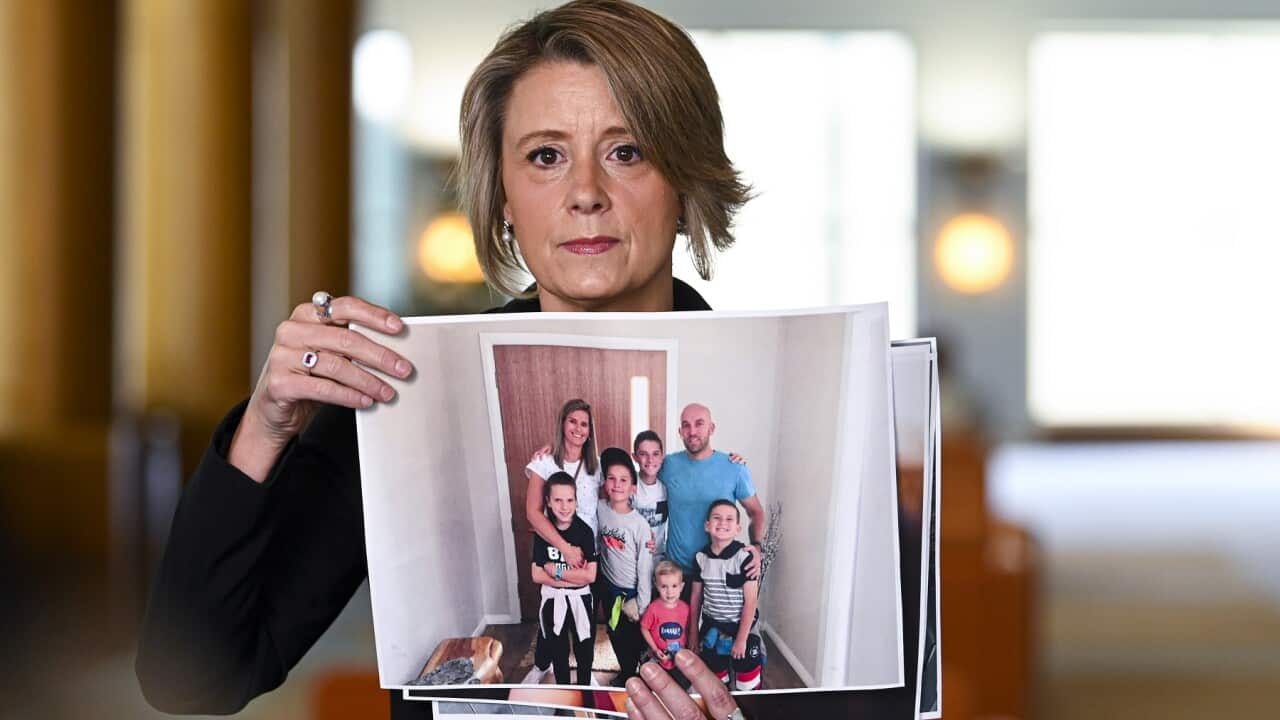 Shadow Immigration Minister Kristina Keneally holds up pictures of stranded Australian citizens during a press conference at Parliament House in Canberra, Thursday, September 24, 2020. (AAP Image/Lukas Coch) NO ARCHIVING