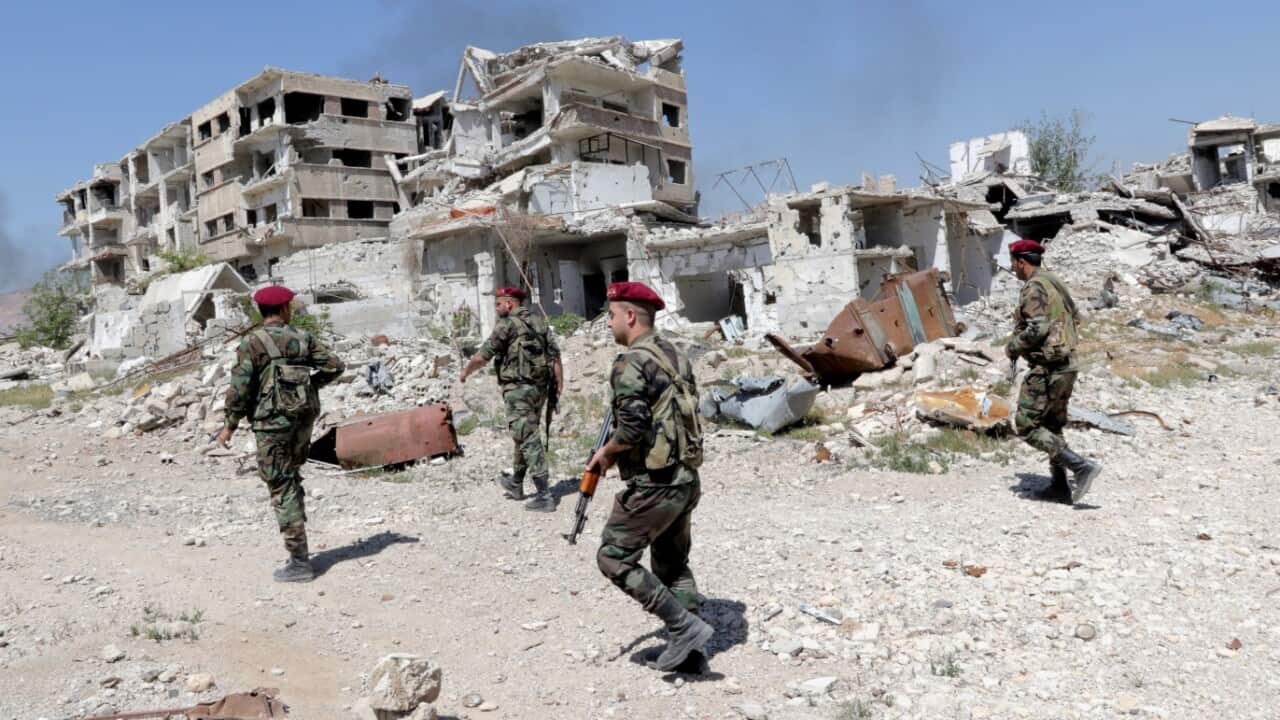 Syrian soldiers patrol in the recently-captured Jobar town in the Eastern Ghouta,