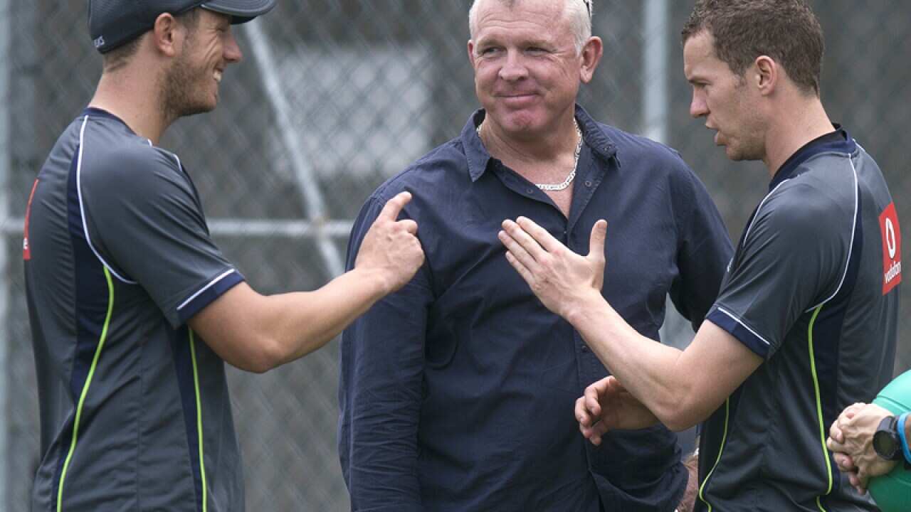 Australian bowling coach Craig McDermott (C)