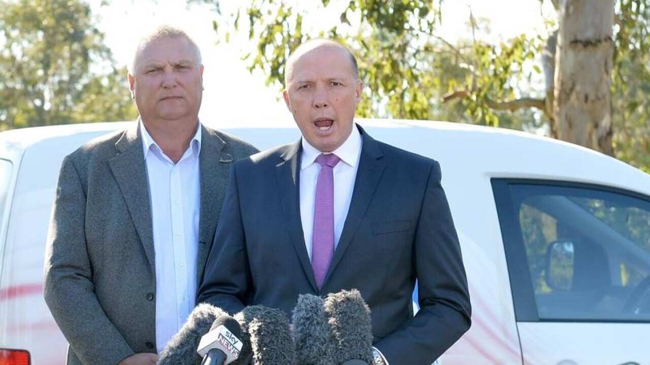 Home Affairs Minister Peter Dutton with LNP candidate for Longman Trevor Ruthenberg.