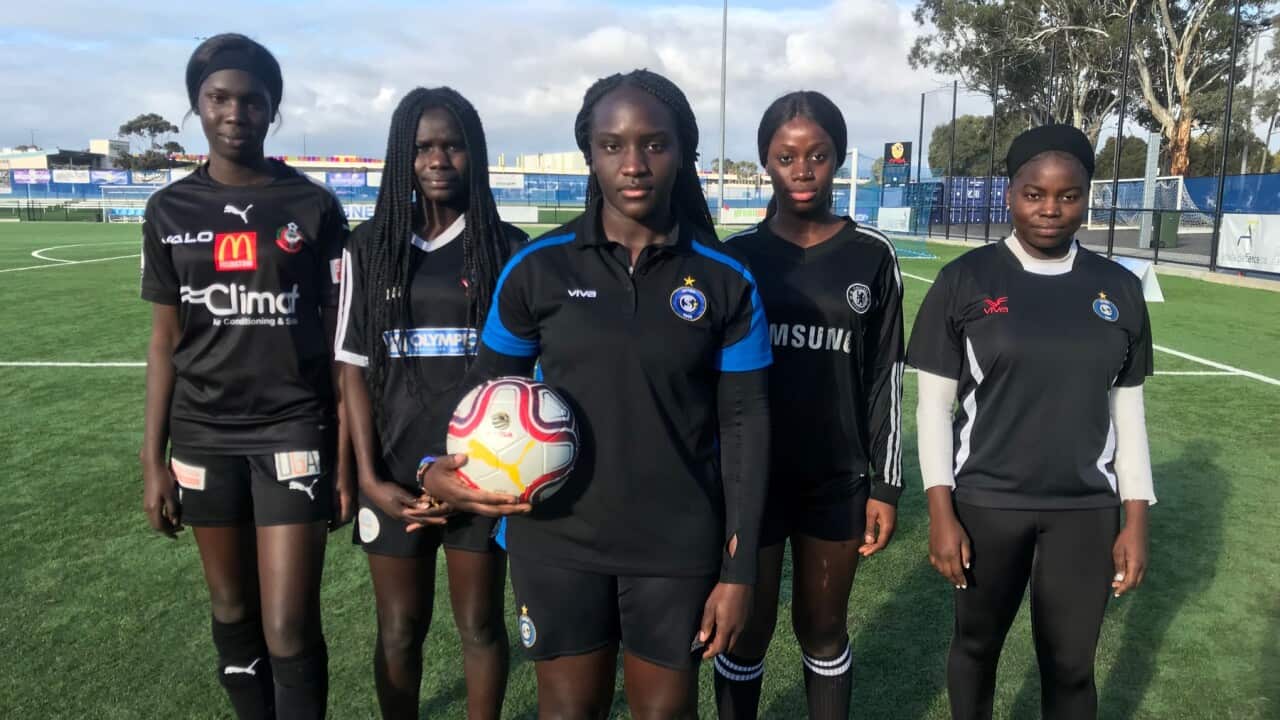 Elizabeth Taban (C) and her team mates