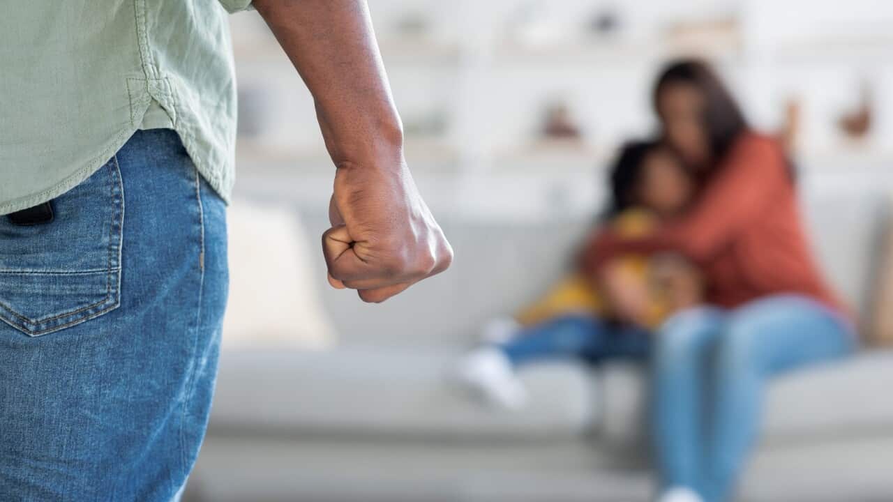 Domestic Violence. African American Man Threatening Wife And Daughter With His Fist