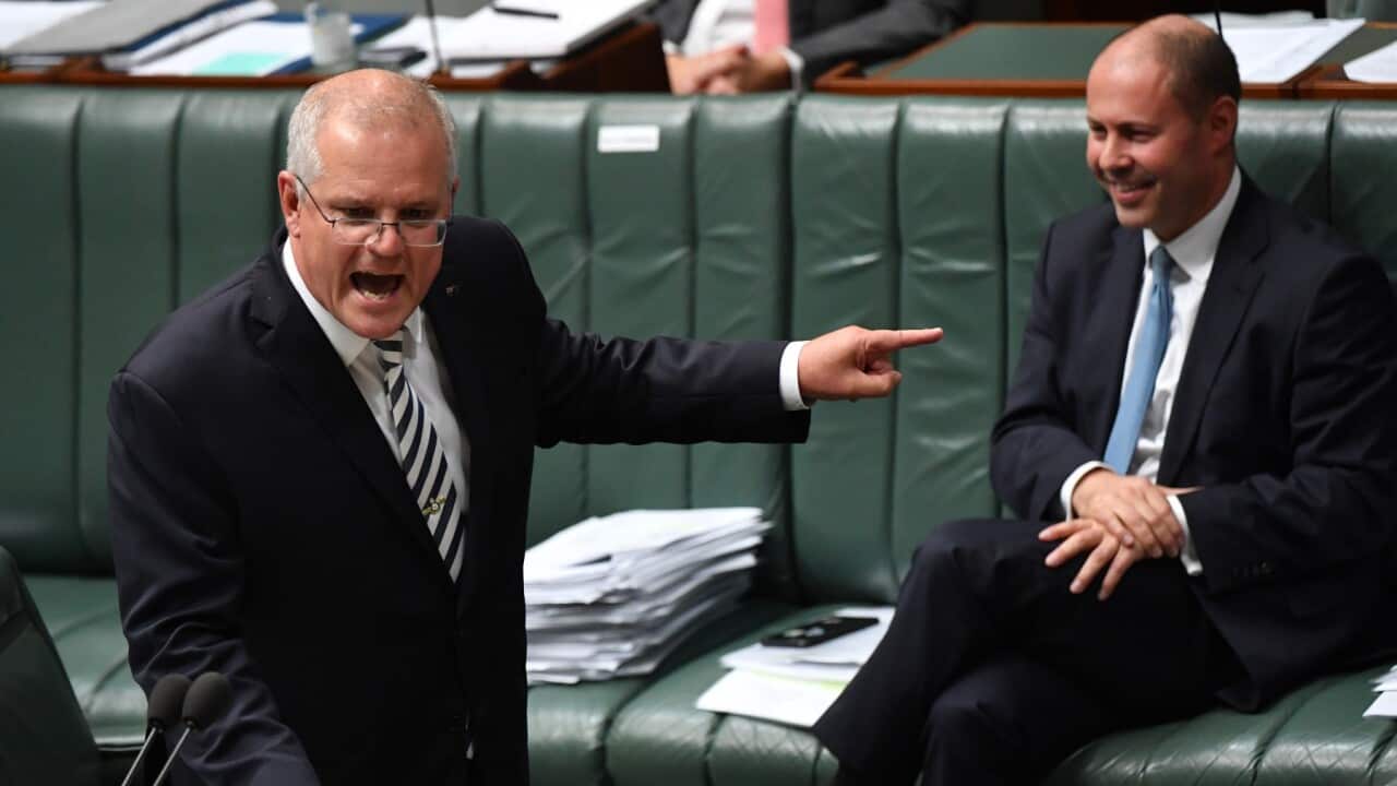 Prime Minister Scott Morrison points at Treasurer Josh Frydenberg during Question Time in the House of Representatives at Parliament House on March 25, 2021 in Canberra, Australia.