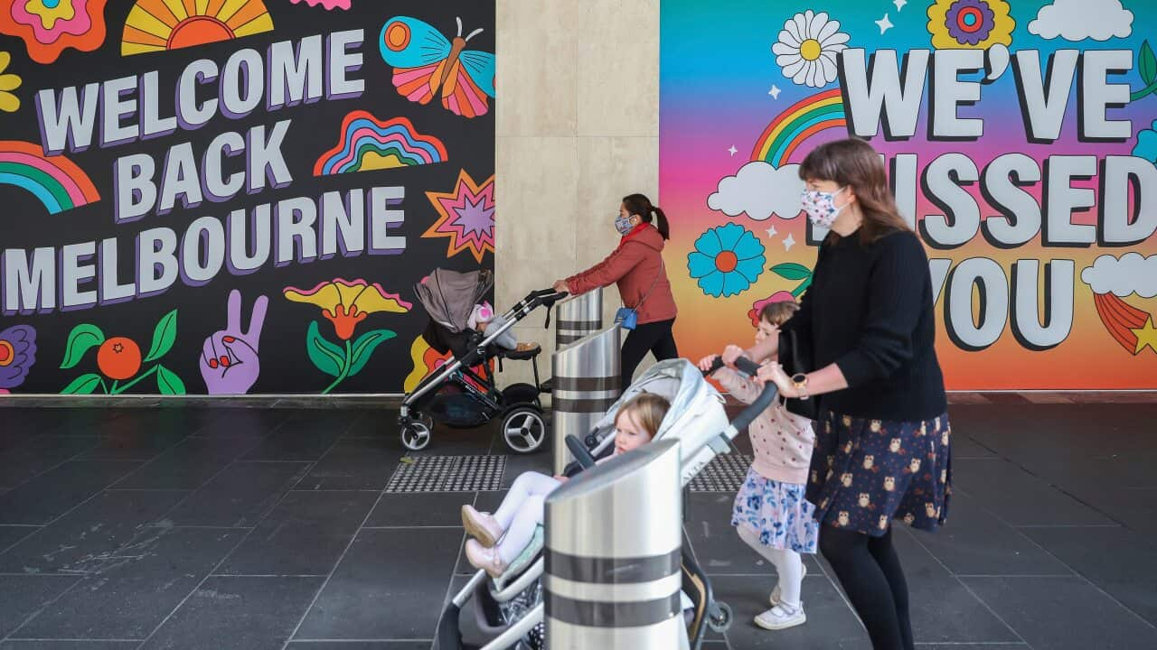 Two women pushing prams wearing masks are seen walking in Melbourne, Wednesday, Oct. 28, 2020. 