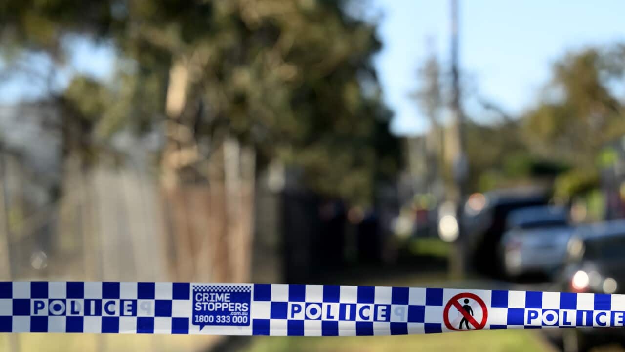 A police banner, with blue and white squares and a blurred background