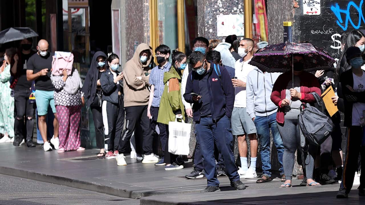 People are seen in a queue at the Russell Street testing clinic in Melbourne, Monday, December 20, 2021.