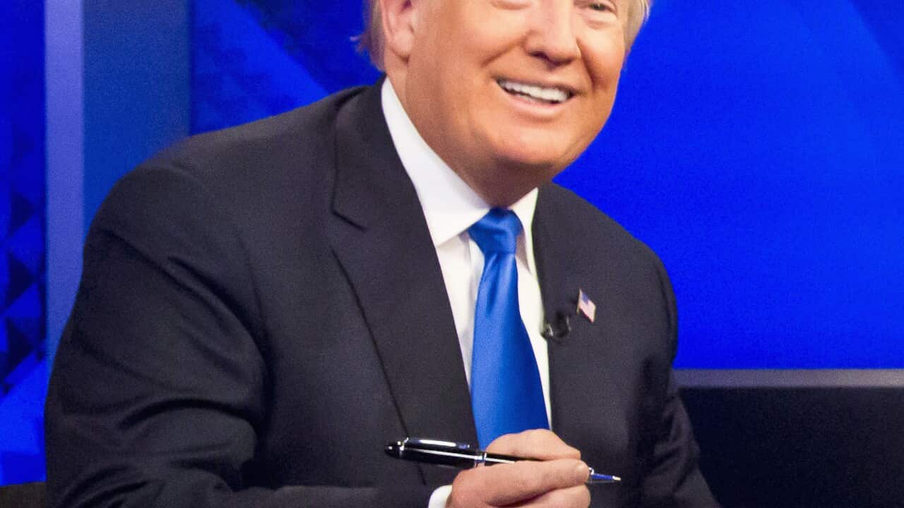 Republican presidential candidate Donald Trump prepares to sign his book during his appearance on Fox's news talk show 'The O'Reilly Factor'