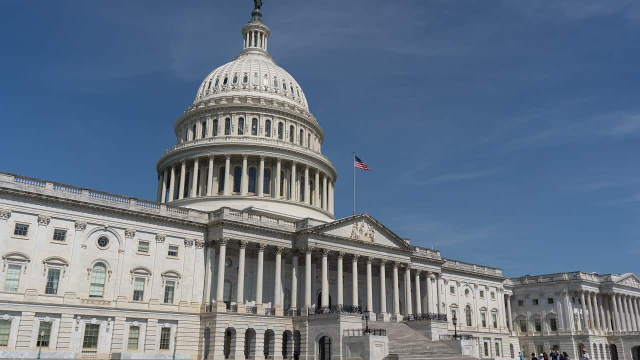 The United States Capitol building in Washington DC, under a clear blue sky.