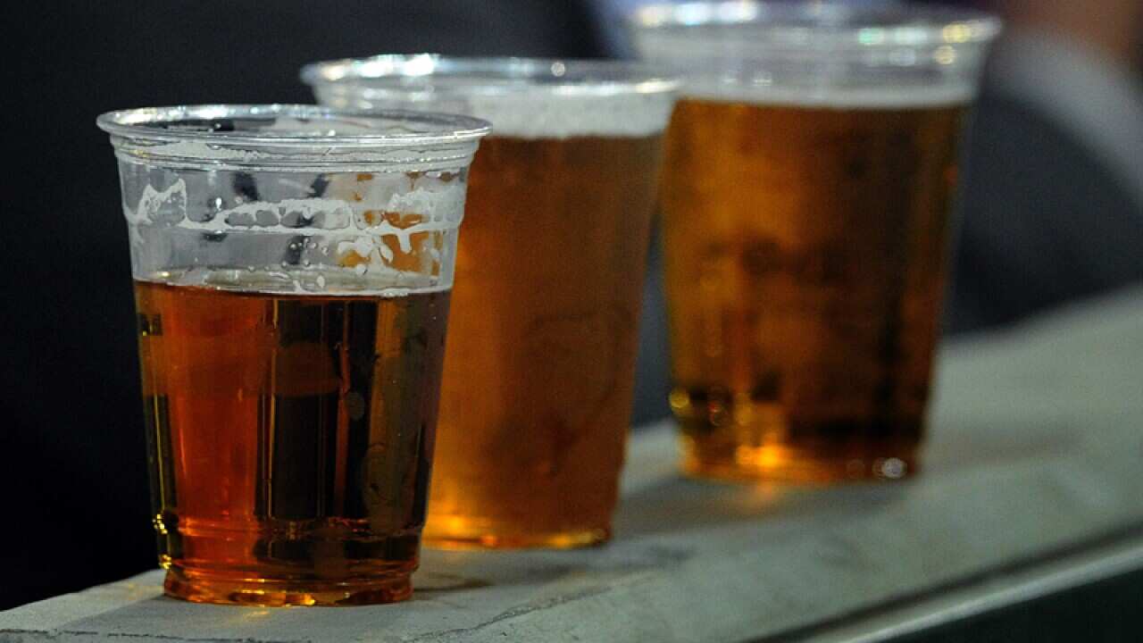 People drinking beer at a sporting venue in Melbourne