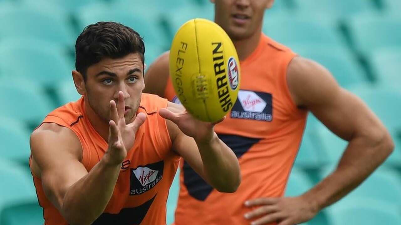 Tim Taranto of the GWS Giants catches a ball during training.