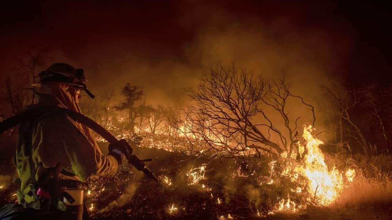 Firefighter Kern Kunst battles the Wall fire near Oroville, Calif
