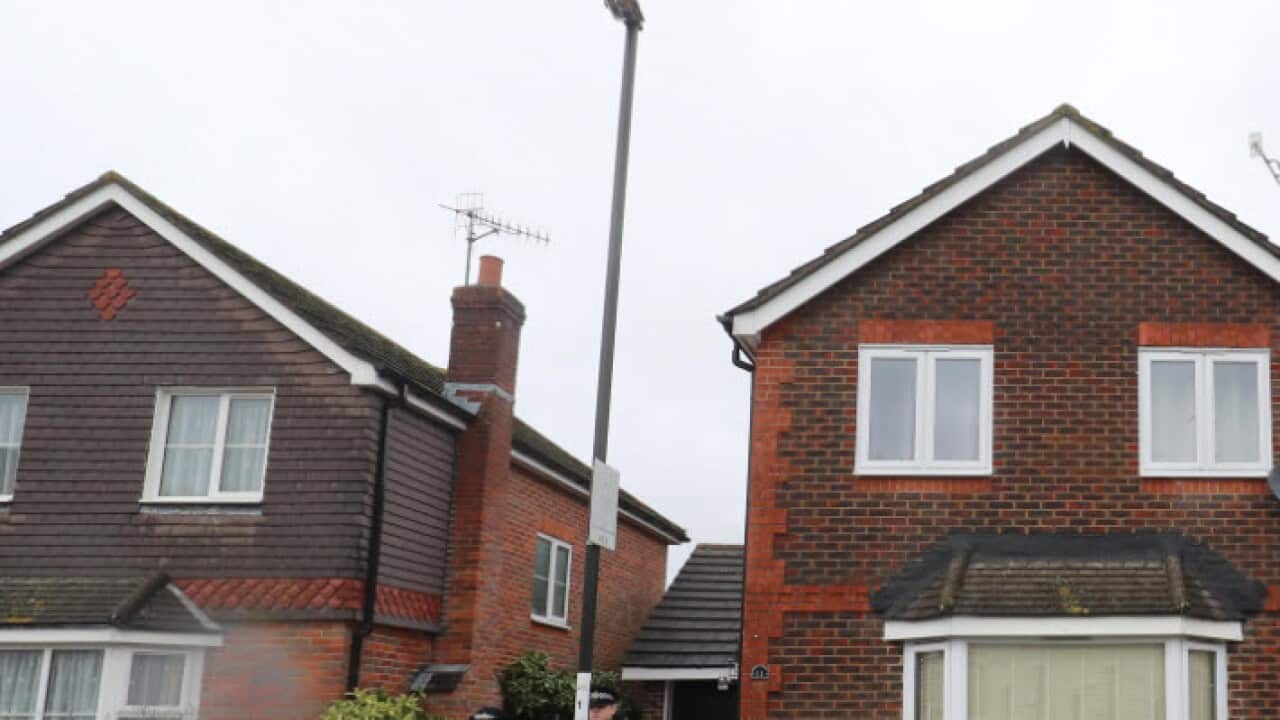 Police outside the home in Crawley, West Sussex, of 47-year-old man and 54-year-old woman who were released without charge in connection with the drone incidents at Gatwick Airport (AAP)