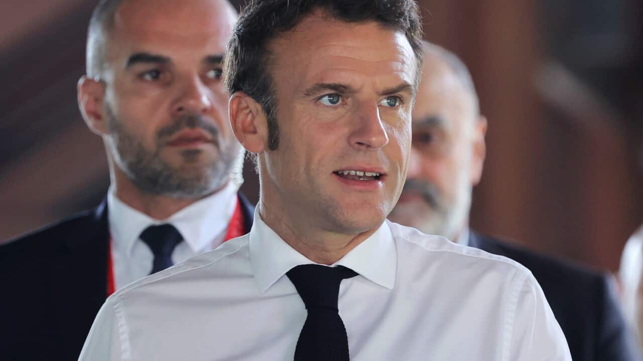 A man wearing a shirt and tie who is speaking.