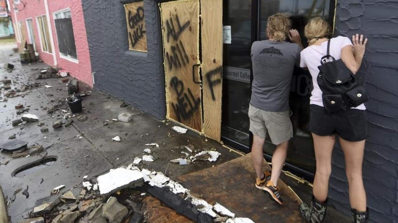 Brett Gurkin and Nadine Antonelli look at what's left of their shop