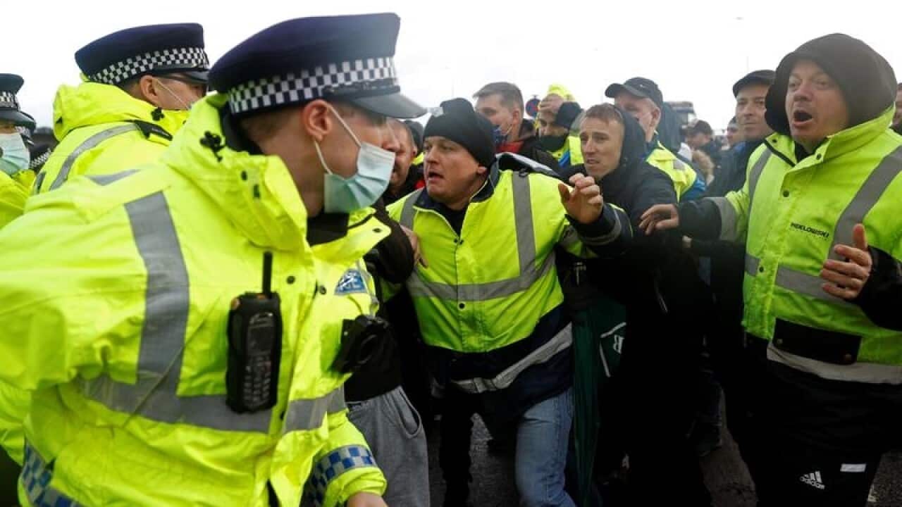 Police officers and truck drivers in Dover, England.