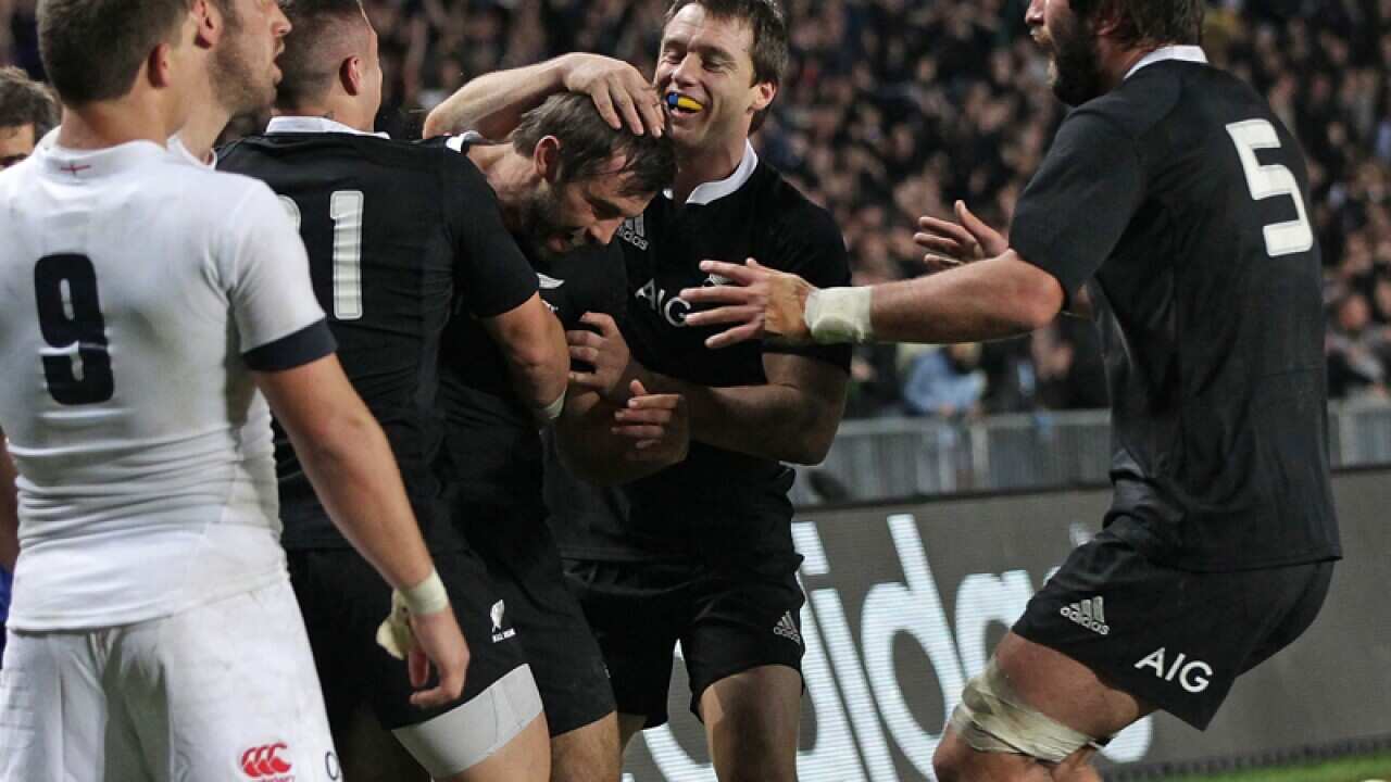 NZ Conrad Smith celebrates with teammates for scoring against England