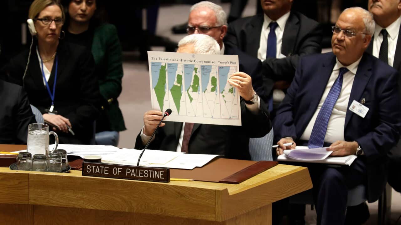 Palestinian President Mahmoud Abbas holds up a document as he speaks during a Security Council meeting at United Nations headquarters, Tuesday, Feb. 11, 2020. (AP Photo/Seth Wenig)
