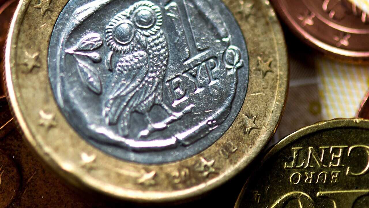 A Greek one Euro coin lies on a table in Duesseldorf, German. (EPA)
