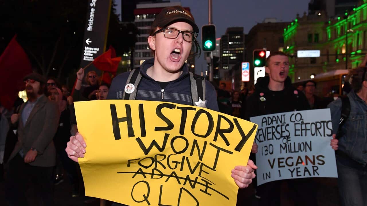 Climate change protestors are seen marching through the streets of Brisbane (AAP Image/Darren England)