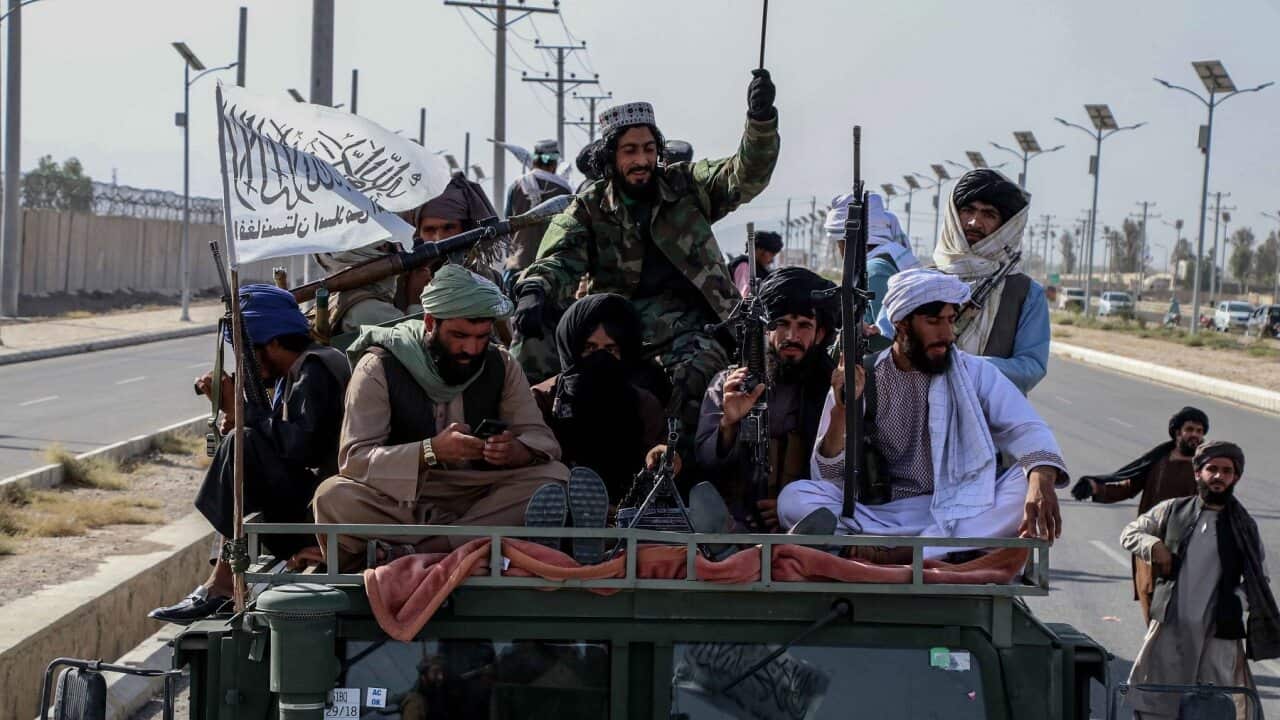 Taliban forces rally to celebrate the withdrawal of US forces in Kandahar