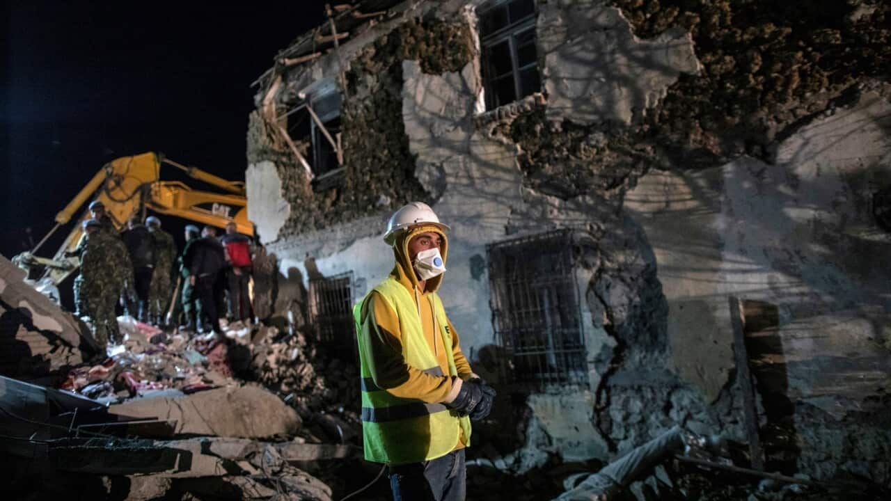 Rescuers search a collapsed building after a magnitude 6.4 earthquake in Thumane, western Albania