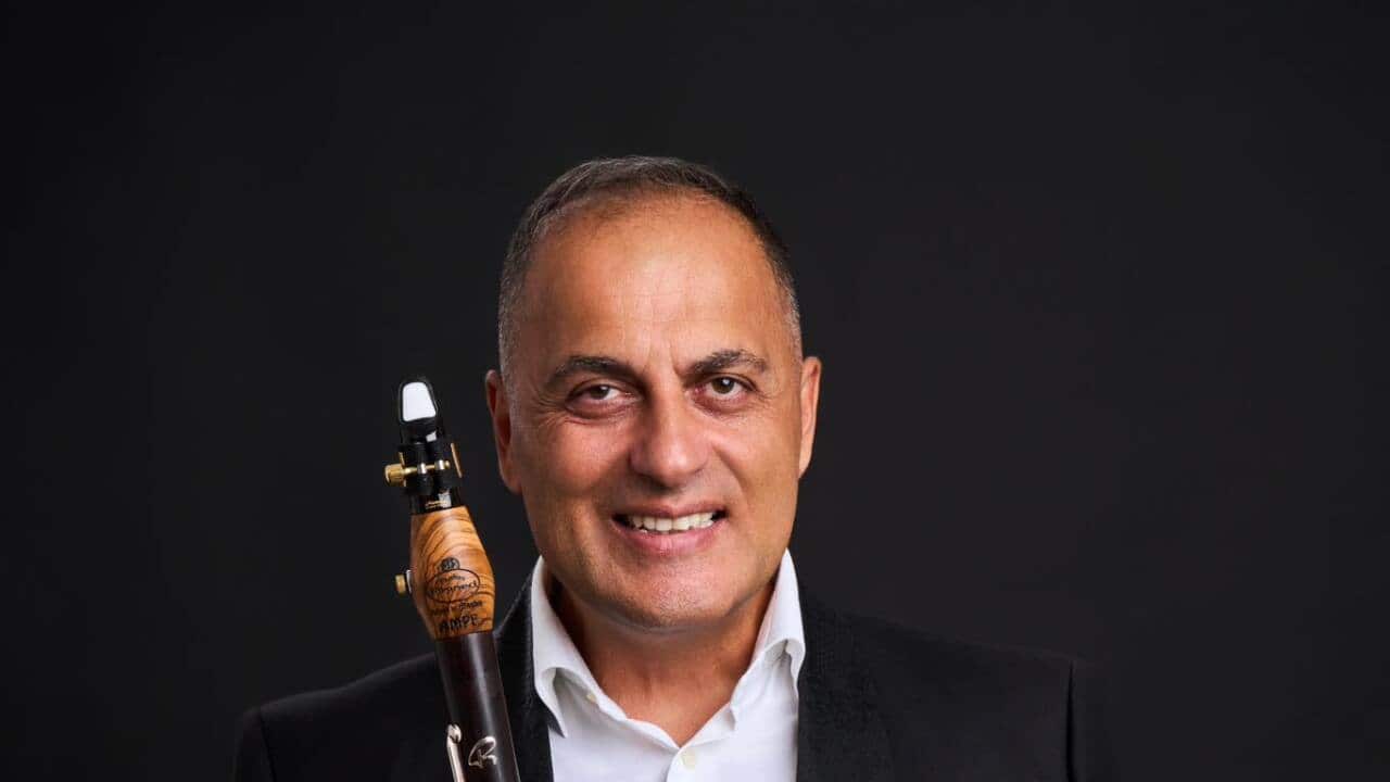 ILIJA AMPEVSKI- PHOTO FB- standing holding clar w black suit white shirt.jpg