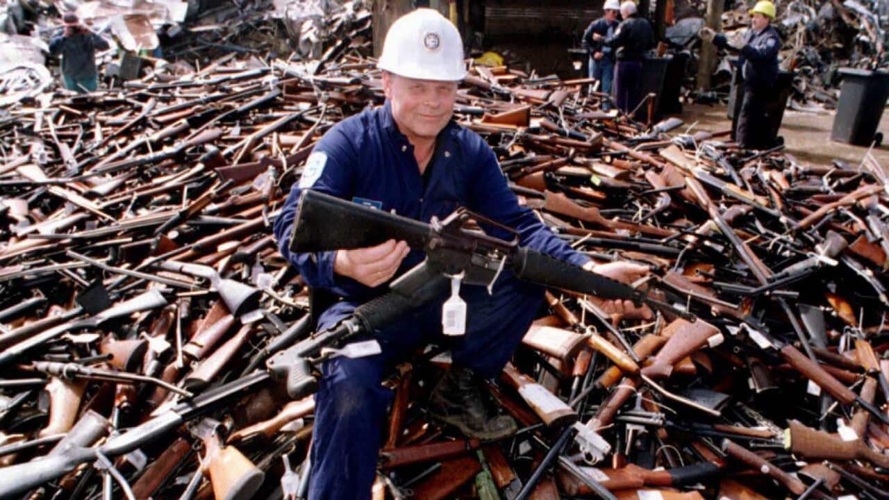 A security official holds an armalite rifle similar to the one used in the Port Arthur massacre, handed in for scrap in the gun amnesty