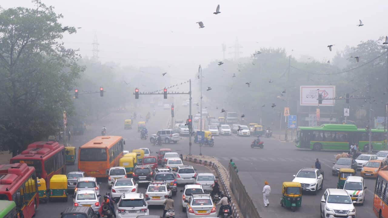Vehicles wait at a crossing in New Delhi, India