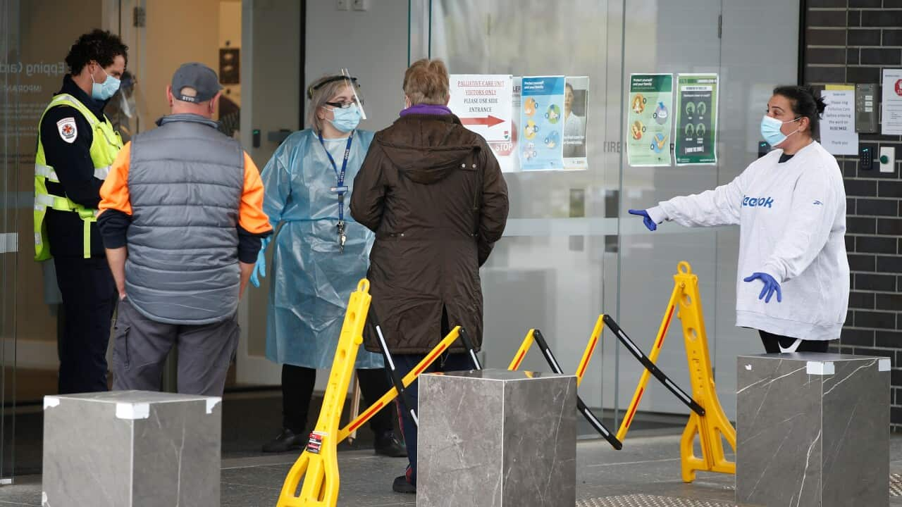 Family members of residents are seen outside Epping Gardens Aged Care Facility in Epping, Melbourne, Tuesday, July 28, 2020. More coronavirus deaths of aged care residents are expected in coming days as Victoria's troubling infection rates continue to spi