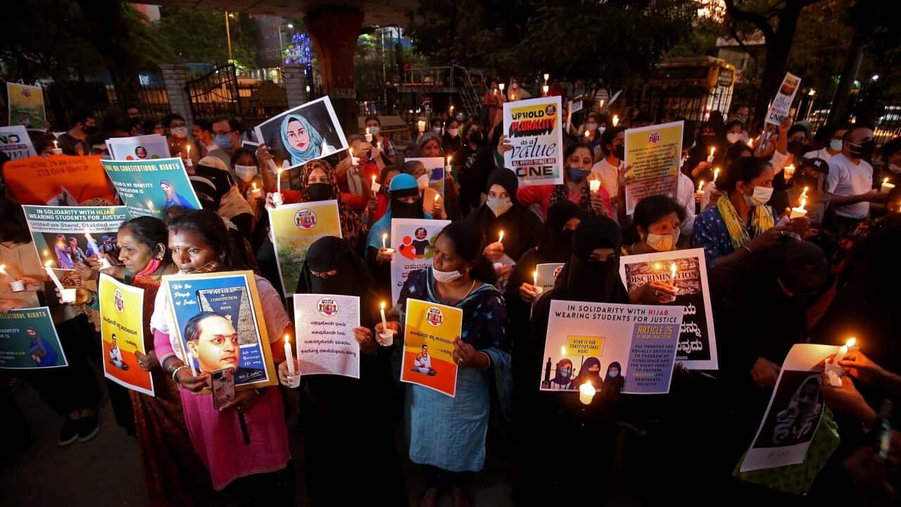 Muslims and allies hold placards and lit candles in solidarity with Muslim women wearing Hijabs at school and colleges in India.