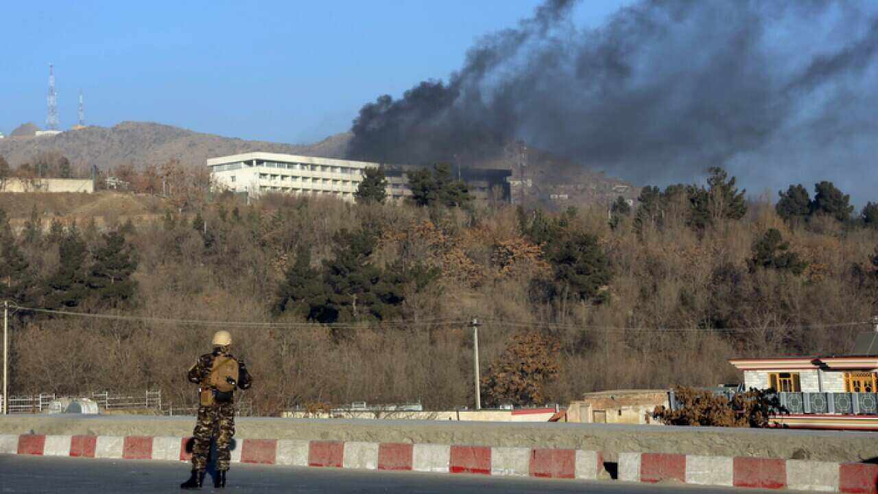 Black smoke rises from the Intercontinental Hotel in Kabul after an attack