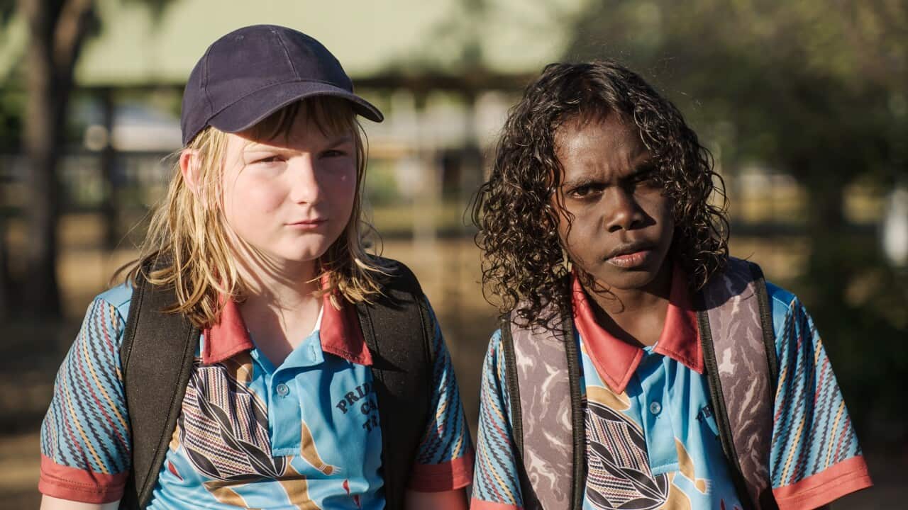 Two young actors, one white girl and one Aboriginal boy, star in new children's series wearing Northern Territory school uniform polo shirts
