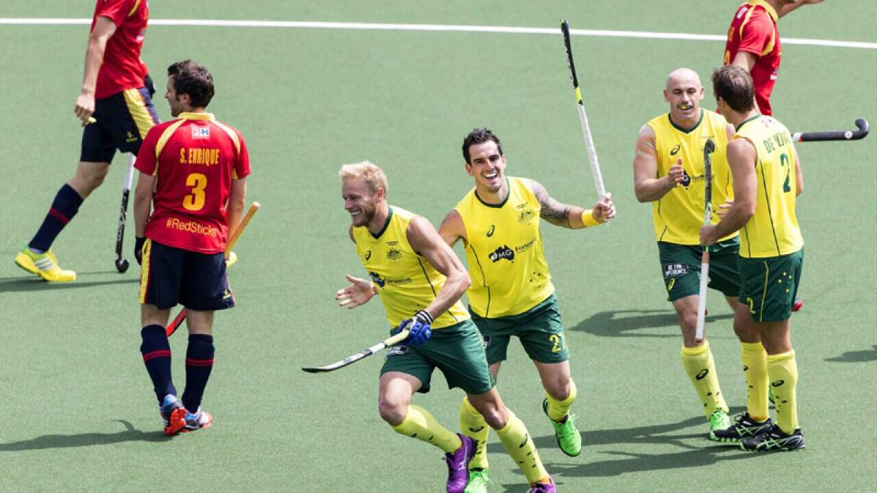Australian hockey players celebrate after scoring a goal