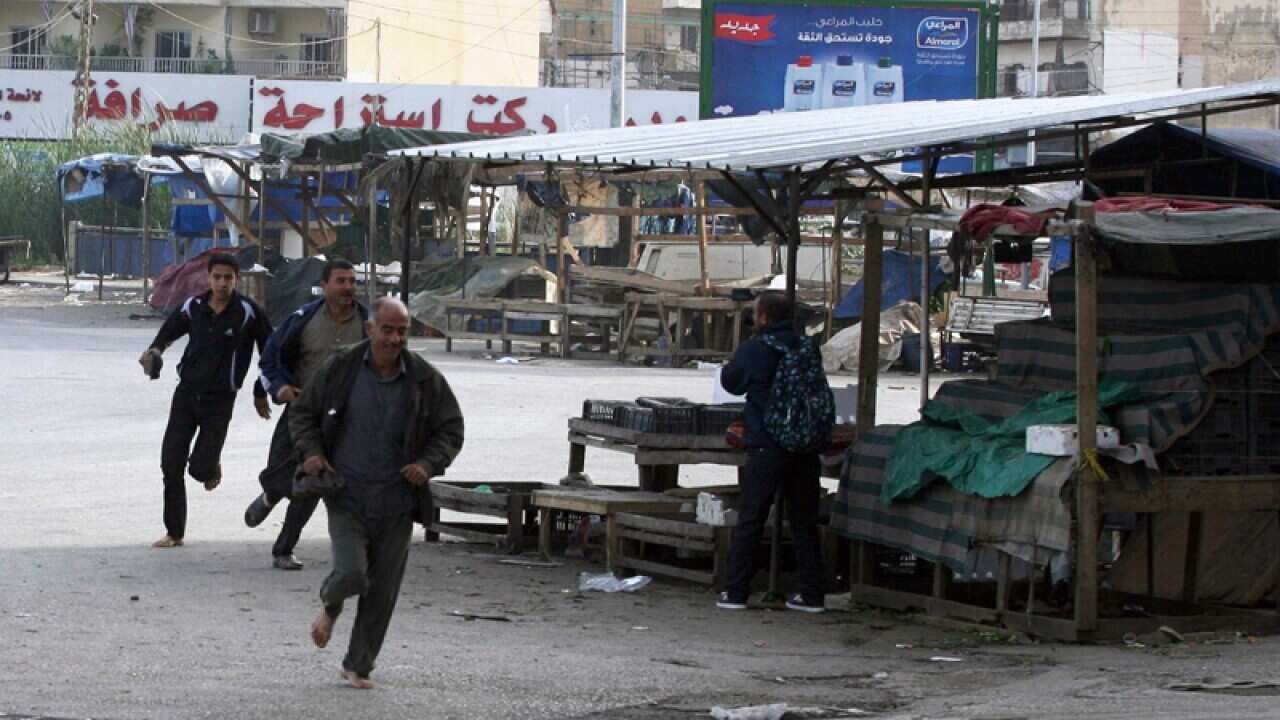 People run for cover from sniper fire in Tripoli