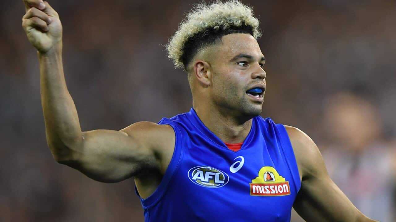 Jason Johannisen of the Bulldogs reacts after kicking a goal