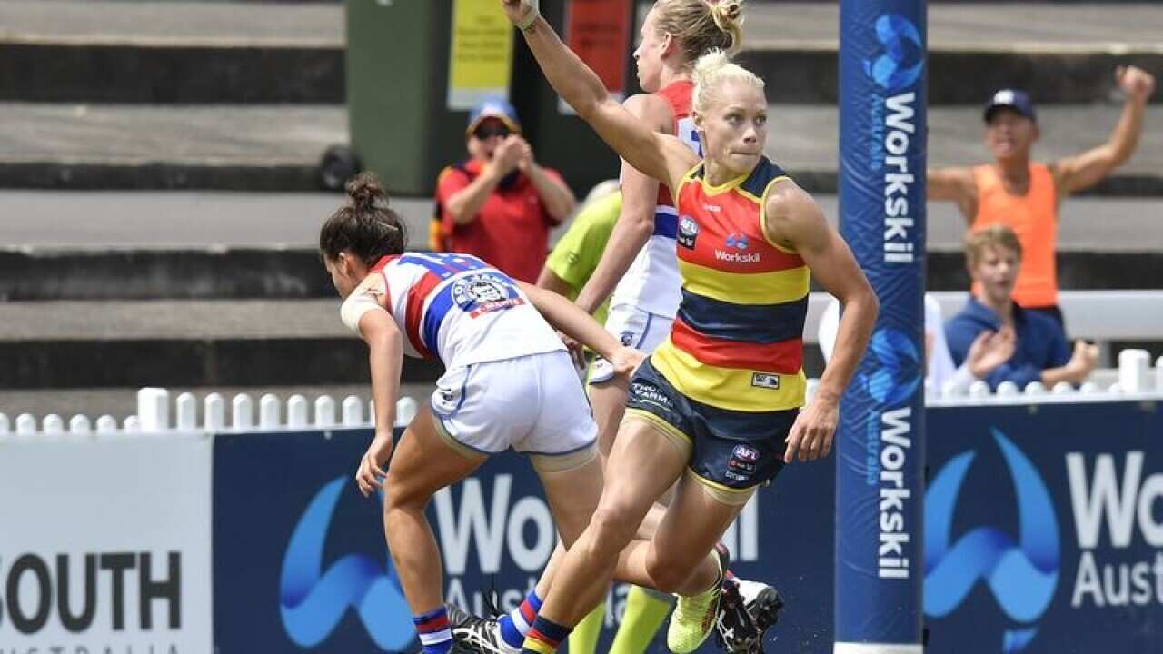 Erin Phillips of the Crows gestures after scoring another goal.