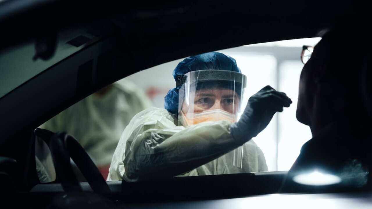 A nurse tests a patient at a COVID-19 testing site in ACT over the weekend.