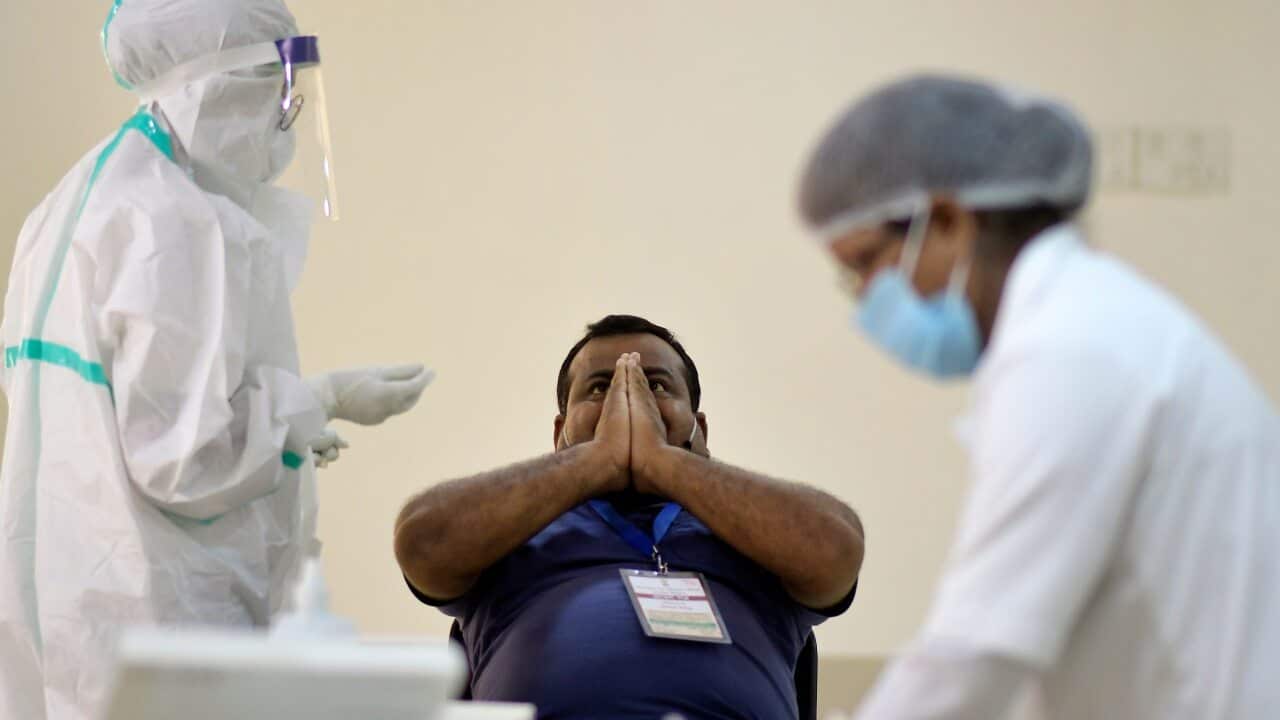 Indian Health workers take swab samples of employees in Guwahati, Assam, India.