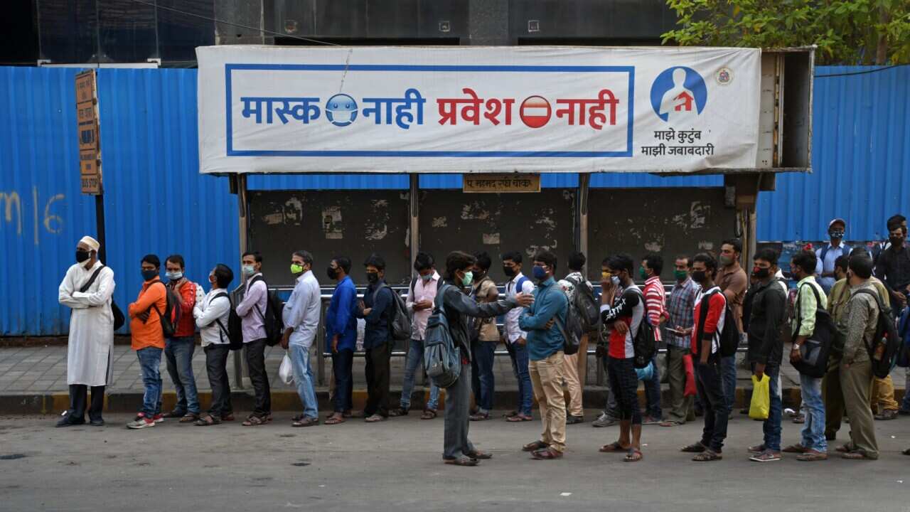 People at a bus shelter in Mumbai