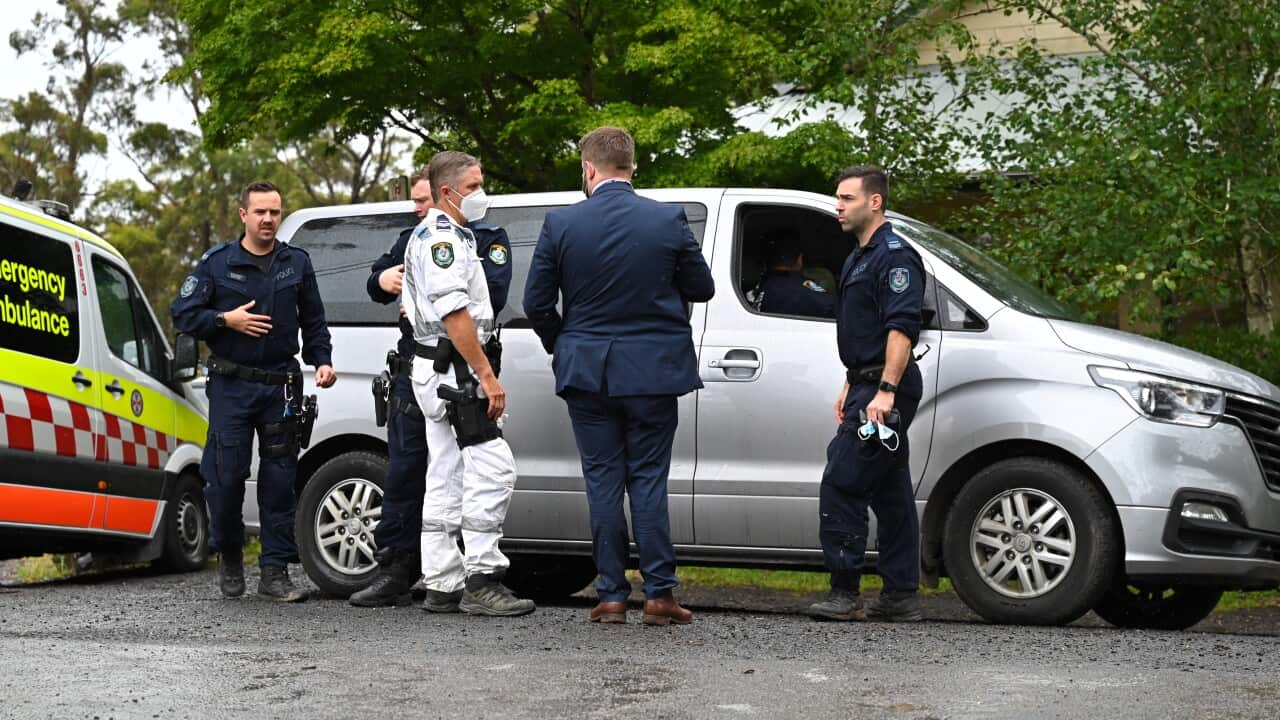 Police speak with each other at a mobile command post in Mount Wilson, north of Katoomba, NSW, Tuesday, 18 January, 2022. 