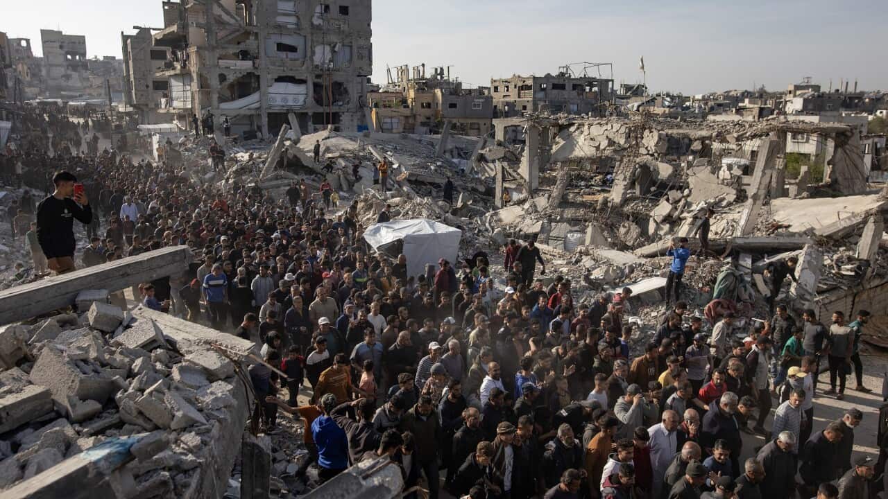 Palestinians chant anti-Hamas slogans as they gather among the rubble of destroyed buildings (AAP)