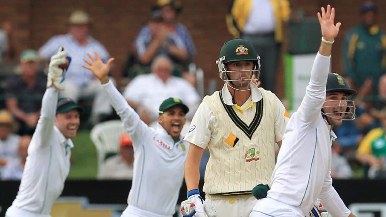 Australia's Nathan Lyon (2nd right) watches South Africa's team