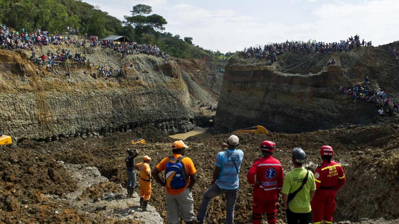Rescuers work on the removal of sludge after a mine collapse