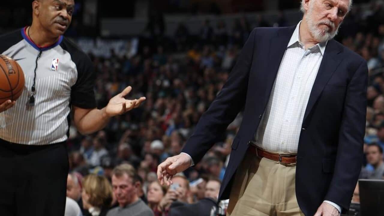 Referee Tony Brothers talks to San Antonio Spurs coach Gregg Popovich.