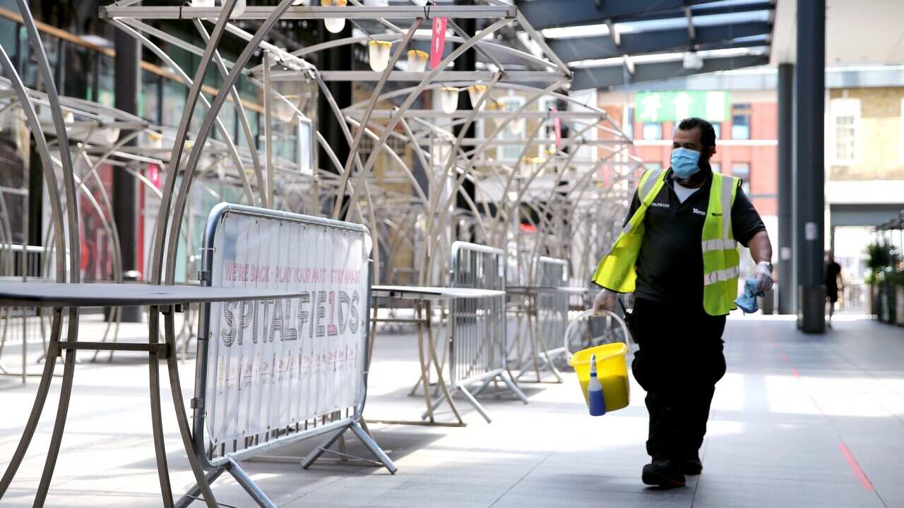 A cleaner walks through Spitalfields Market in East London, as the market has rearranged its stalls layout to respect social distance guidelines, as the government begins easing some lockdown measures in England. Picture date: Monday June 1, 2020..