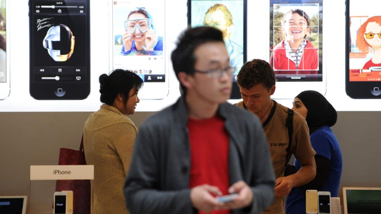 A man uses an iPhone at the Apple store in Sydney