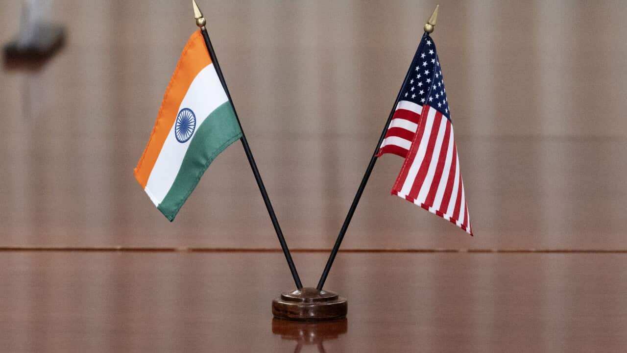 India and US flags on a table.