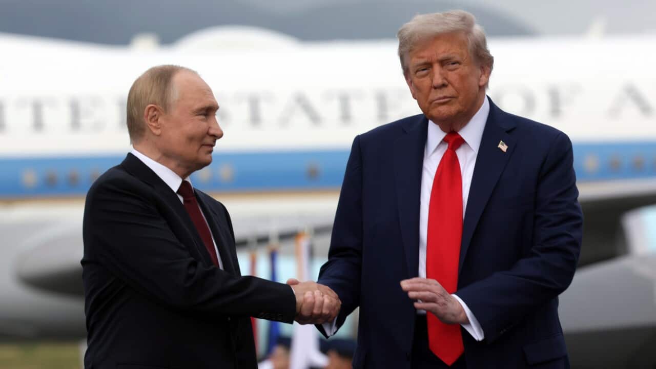 US President Donald Trump (R) and Russian President Vladimir Putin pose on the podium on the tarmac after they arrived to attend a meeting at Joint Base Elmendorf-Richardson in Anchorage, Alaska, USA, 15 August 2025.