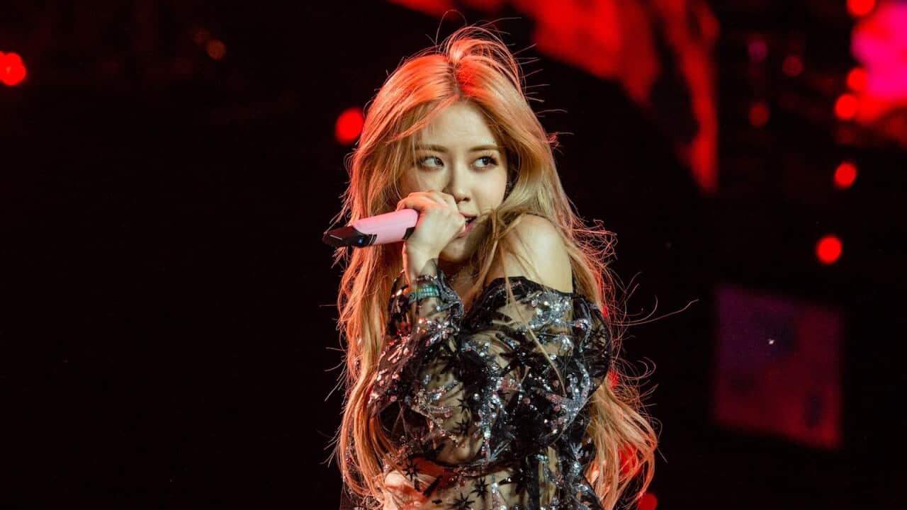 A woman singing into a microphone.