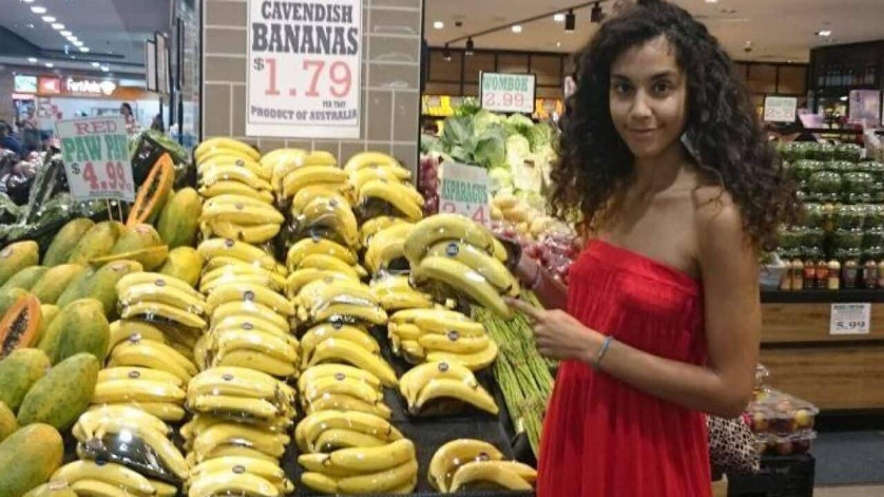 Bananas wrapped in single-use plastic packaging.